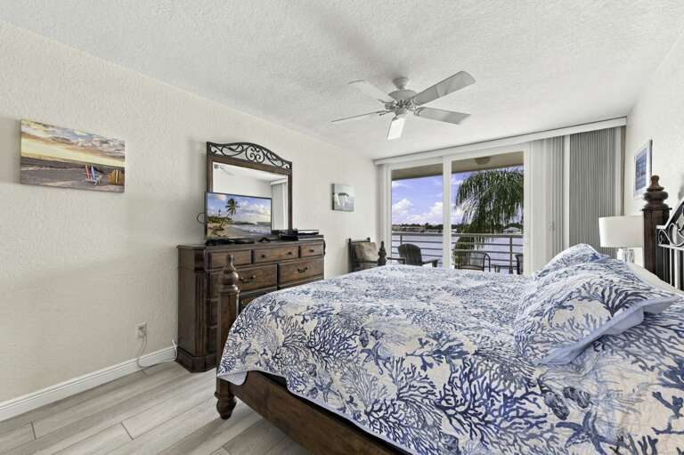 Wake up to gorgeous waterfront views from the primary bedroom.jpg