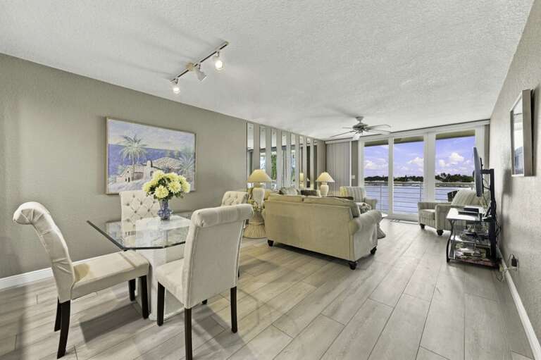 Bright open living and dining area with beautiful waterfront views.jpg
