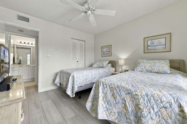 Spacious guest bedroom with two beds, perfect for family or friends.jpg