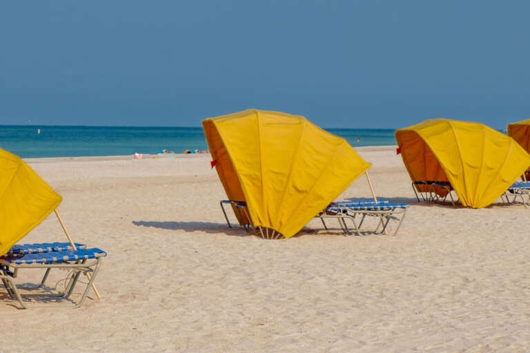 Yellow Cabanas On Sandy Shore
