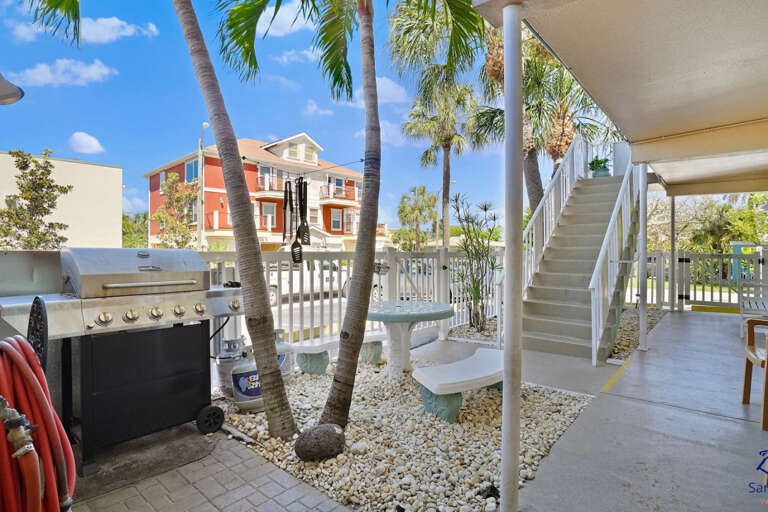 Convenient community BBQ grill and outdoor seating area, perfect for grilling your favorite meals during your beach vacation.