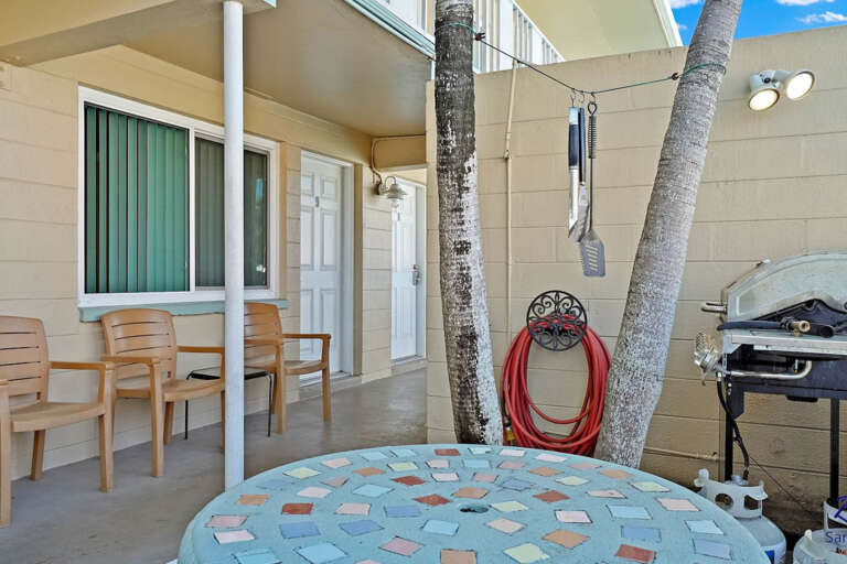 Convenient community BBQ grill and outdoor seating area, perfect for grilling your favorite meals during your beach vacation.