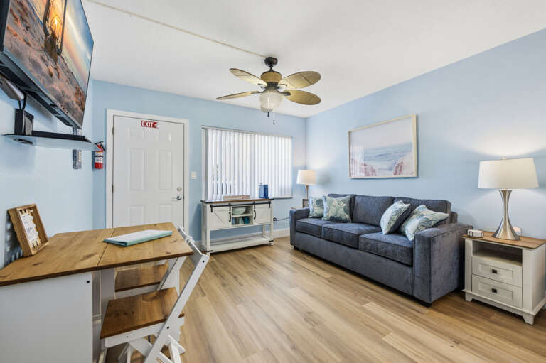 Inviting coastal living area with comfortable sofa, Smart TV, dining space, and a bright open layout for your Gulf Coast vacation.
