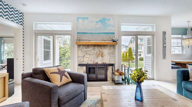 Bright Beach-themed Living Space With Stone Fireplace And Seaside Decor