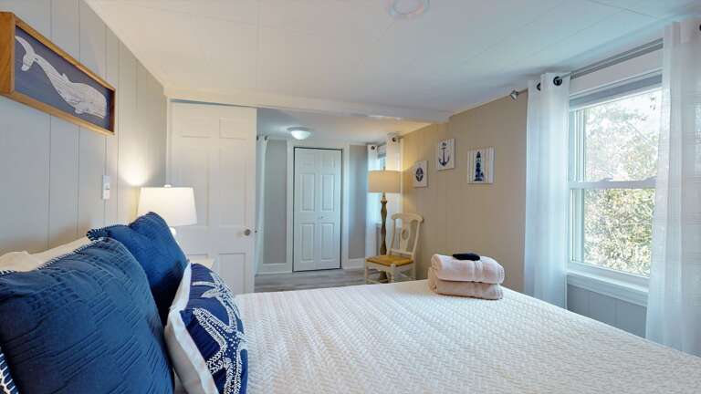 Bright Bedroom With Blue Accents In Vacation Rental