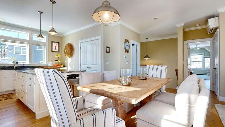Bright Vacation Rental Interior Showcasing Dining And Kitchen Spaces