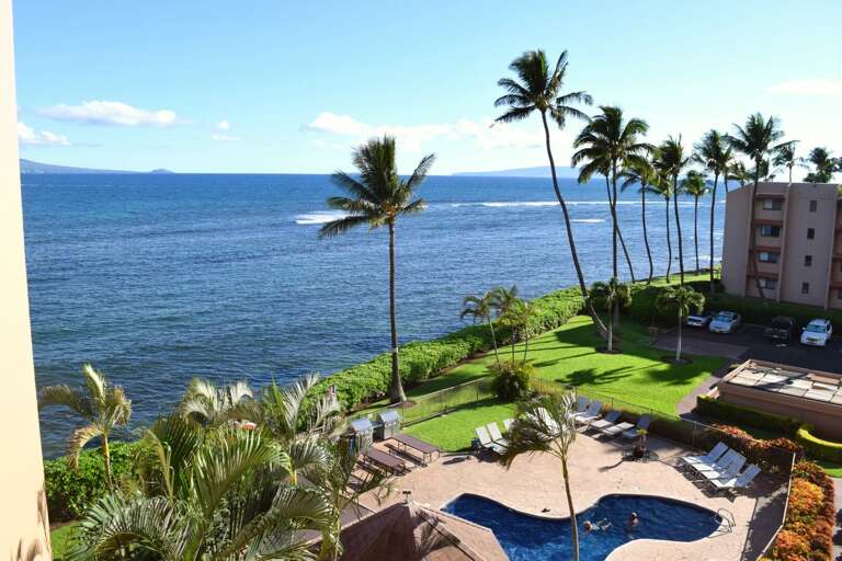 View of property pool and ocean from lanai