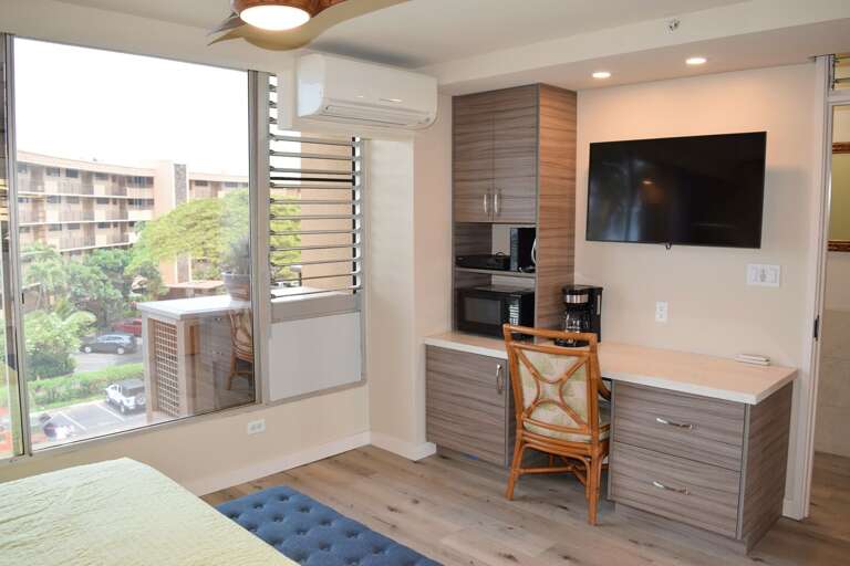 Bedroom with desk and flat screen tv