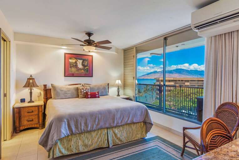 Spacious guest bedroom with partial ocean and mountain views