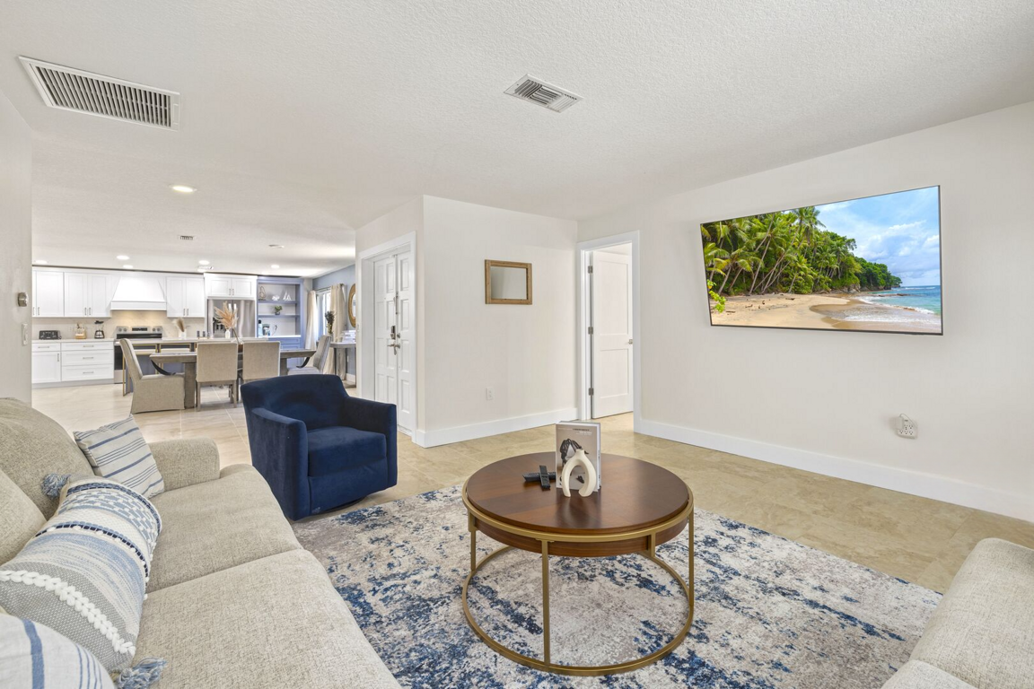 Large open layout with cozy seating, kitchen access, and a mounted TV for added comfort. Large open layout with cozy seating, kitchen access, and a mounted TV for added comfort.