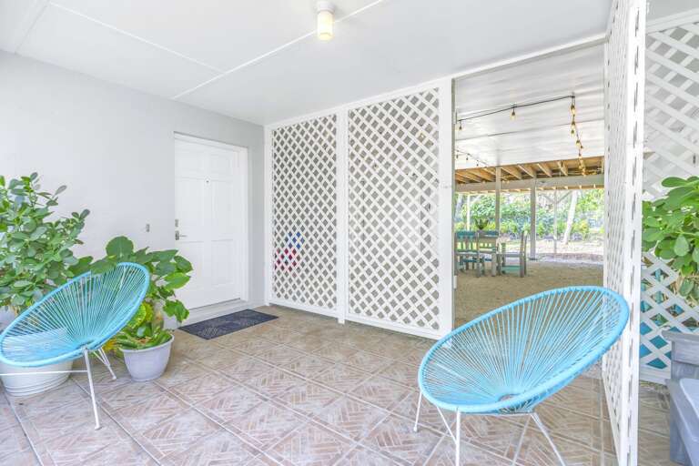 Patio With Two Blue Chairs And Lattice Divider