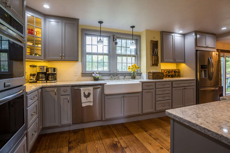 Kitchen Interior With Wooden Flooring And Gray Cabinets Kitchen Interior With Wooden Flooring And Gray Cabinets