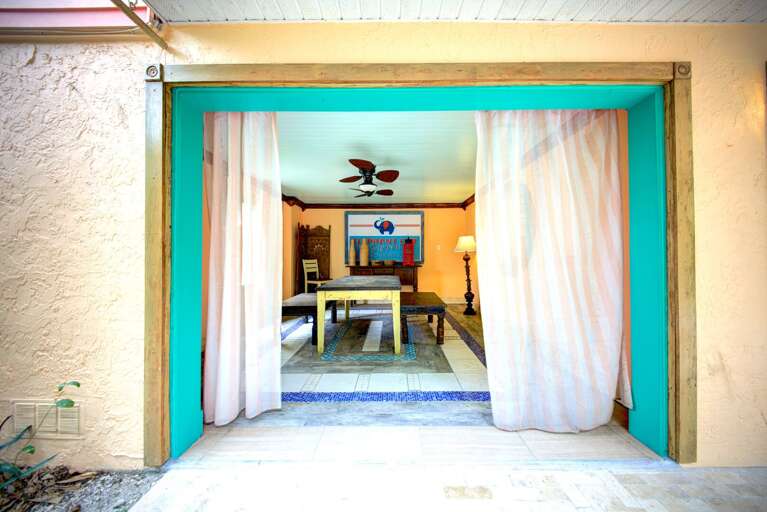 Dining, lounging, and tiki bar on garden patio, Siesta Key Village 6BR