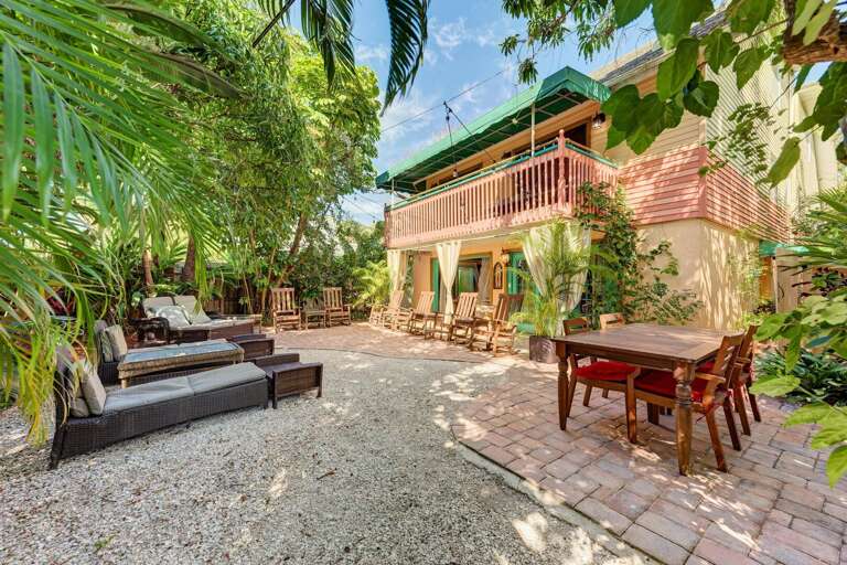 Dining, lounging, and tiki bar on garden patio, Siesta Key Village 6BR