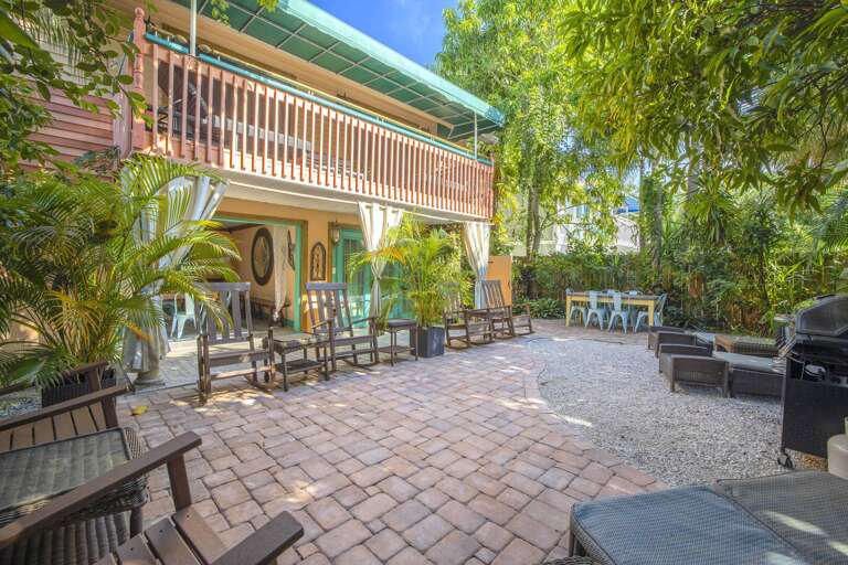 Dining, lounging, and tiki bar on garden patio, Siesta Key Village 6BR