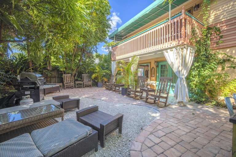 Dining, lounging, and tiki bar on garden patio, Siesta Key Village 6BR