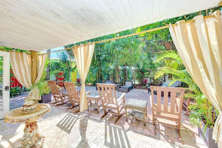 Dining, lounging, and tiki bar on garden patio, Siesta Key Village 6BR