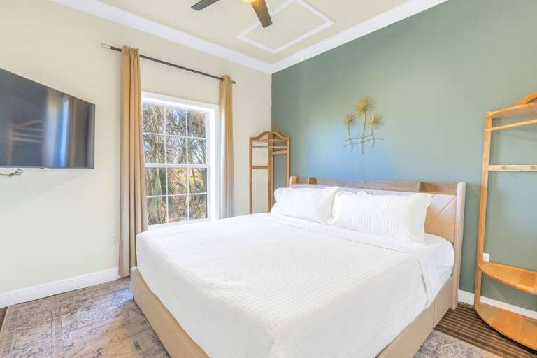 Bright Bedroom With Bunk Beds, Big Window, And Wall-mounted TV