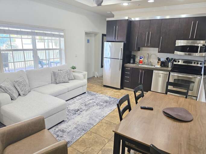 Interior View Showing Kitchen, Dining Area, And Living Room With Light Furnishings Interior View Showing Kitchen, Dining Area, And Living Room With Light Furnishings