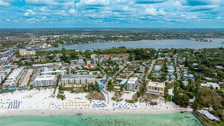Aerial View Of A Vibrant Vacation Venue By The Beach Aerial View Of A Vibrant Vacation Venue By The Beach