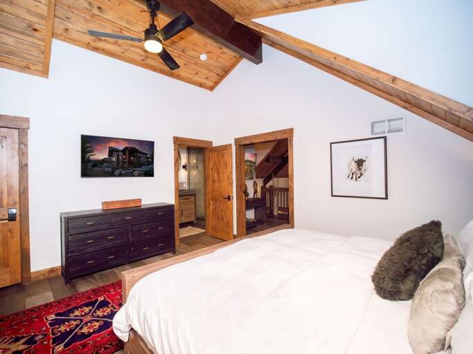 Upper level master bedroom with attached private bathroom and 50 inch smart TV