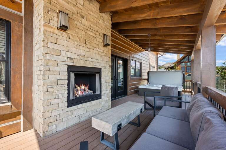 Outdoor patio with fireplace and private hot tub