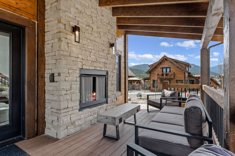 Outdoor patio with fireplace and private hot tub