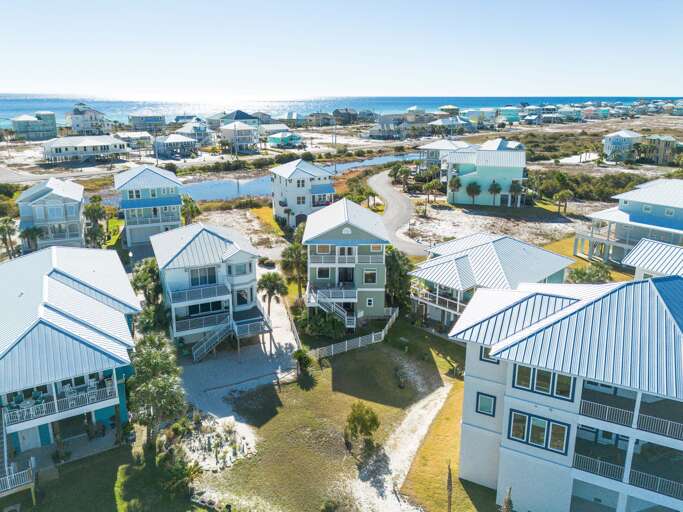 Aerial view of the rear view of house with pathway down to the bay