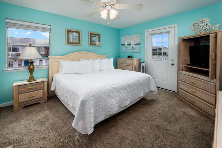 Master bedroom with a king size bed and balcony