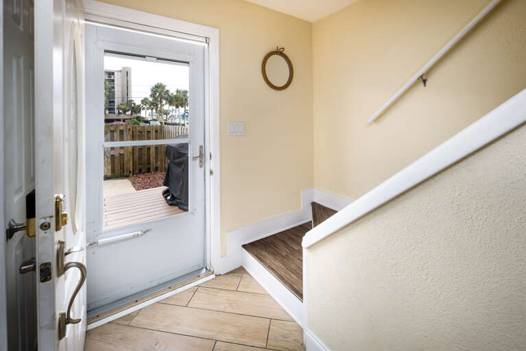 Door to back yard with sun deck and grilling area