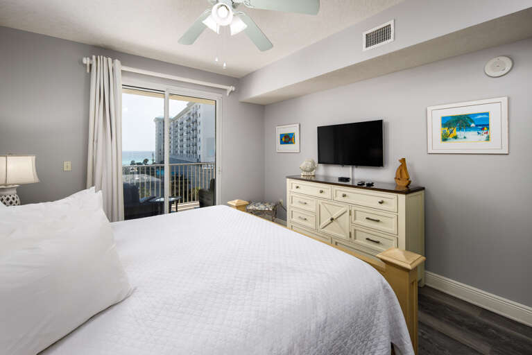 Master bedroom with TV and sliders to the balcony