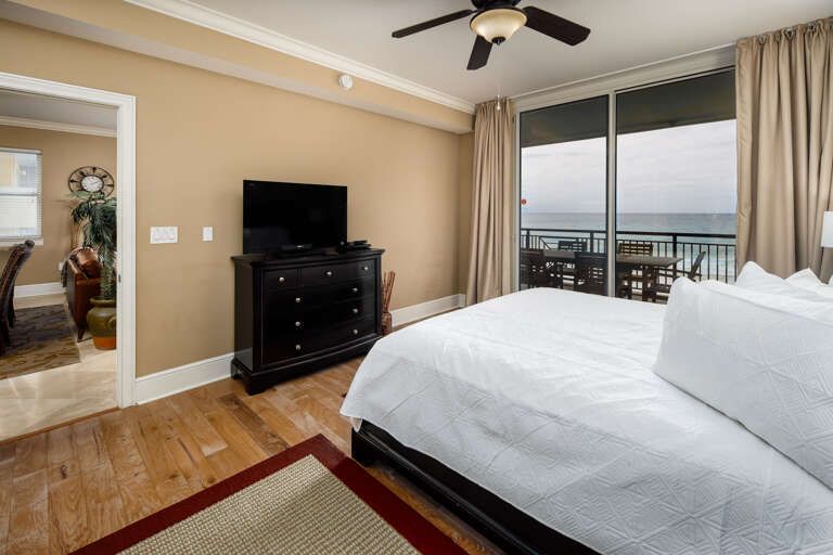 Master bedroom with TV and balcony access