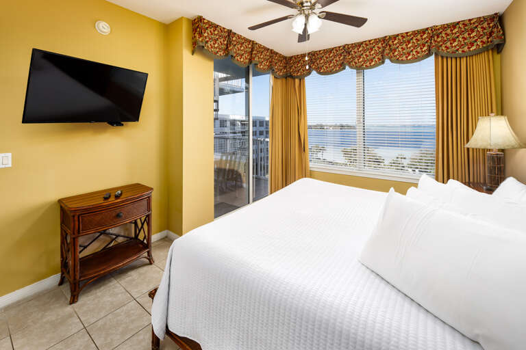 Master bedroom with TV and balcony access