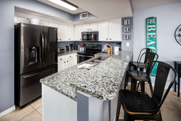 Fully stocked kitchen with breakfast bar Fully stocked kitchen with breakfast bar