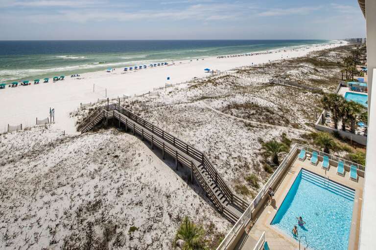 Beach boardwalk and pool views from balcony