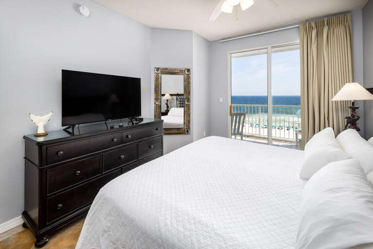 Master bedroom with TV and balcony access