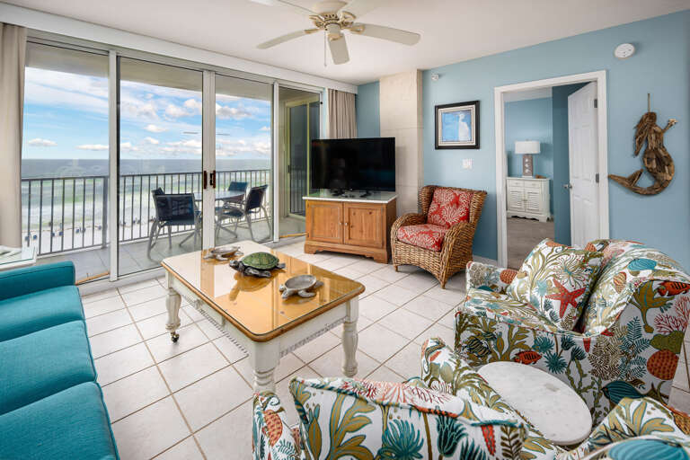 Living room with balcony access and beach views