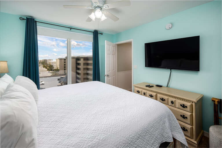 Master bedroom with TV and balcony access