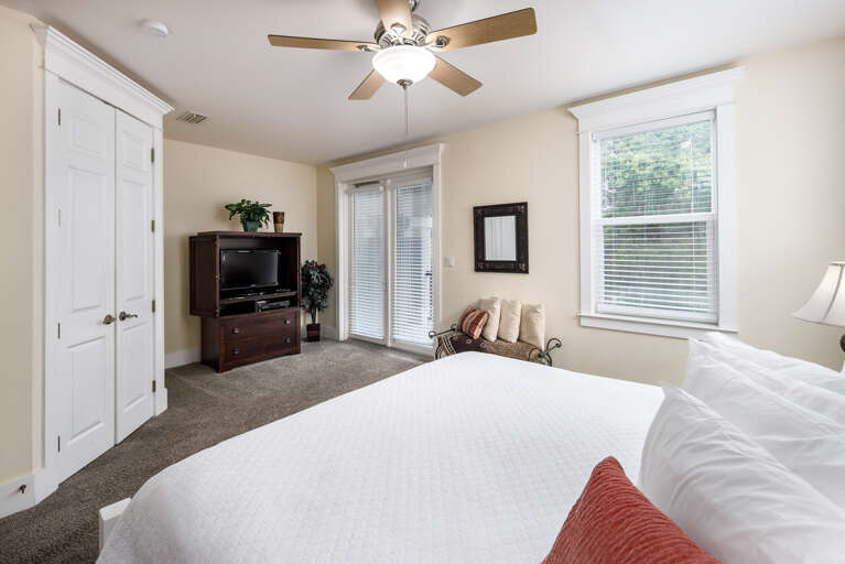 Second floor master bedroom with king size bed and balcony access