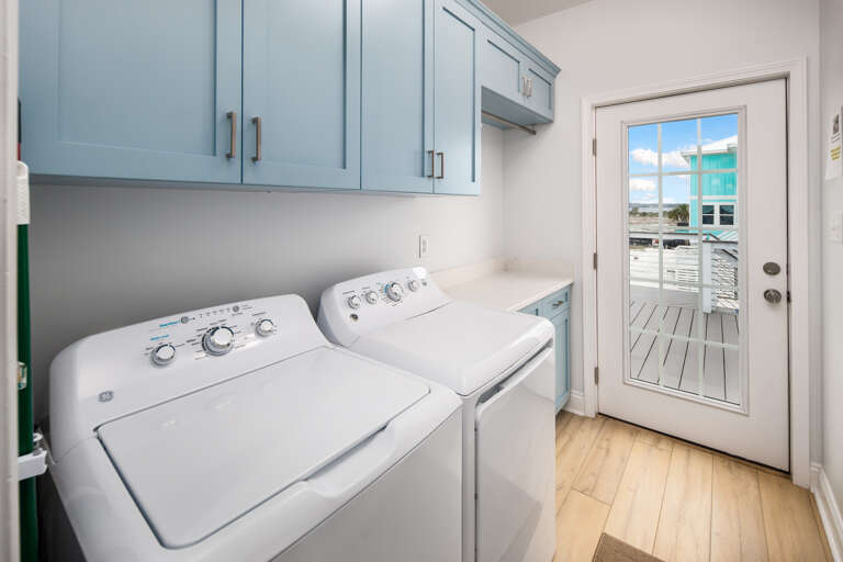 Laundry room with full size washer and dryer with back deck access