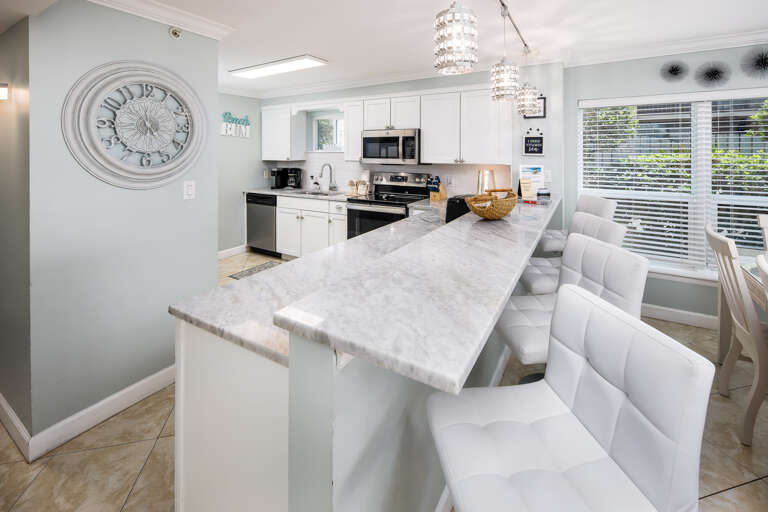 Beautiful Stone Countertops & Breakfast Bar with High Back Barstools Beautiful Stone Countertops & Breakfast Bar with High Back Barstools