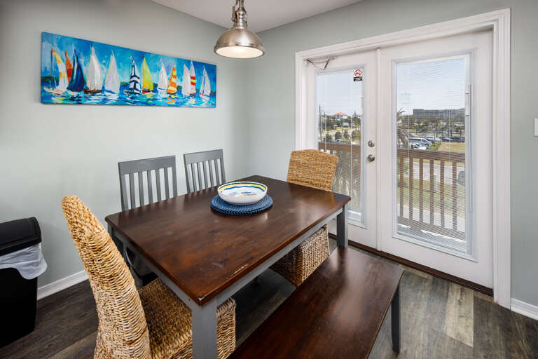 Dining area with seating for six and balcony access Dining area with seating for six and balcony access