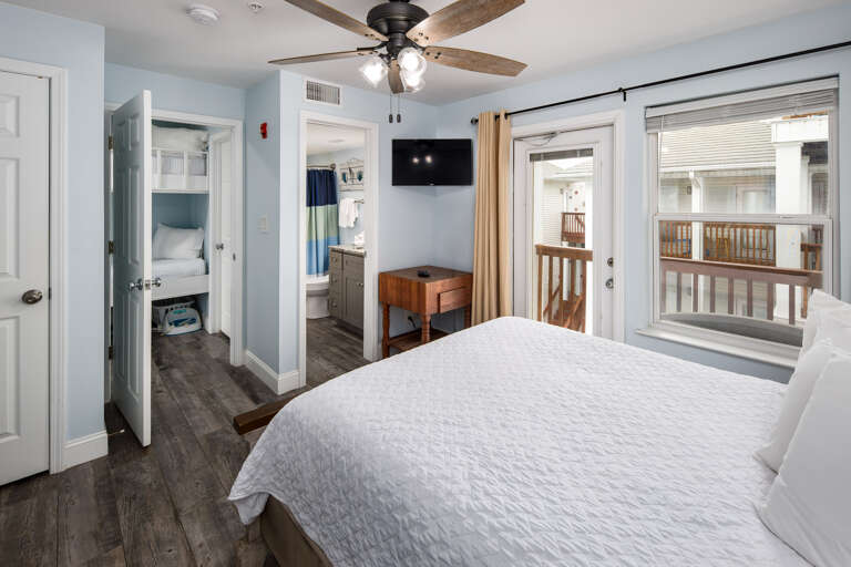 Second bedroom with TV and balcony access