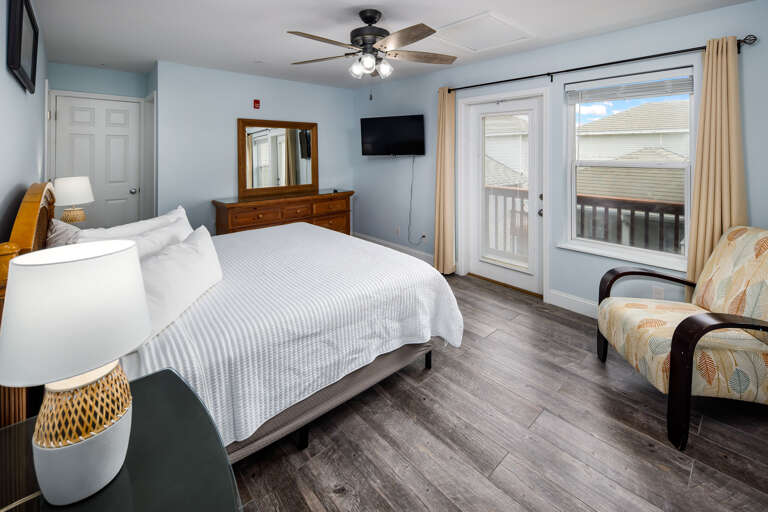 Second floor master bedroom with TV and balcony access