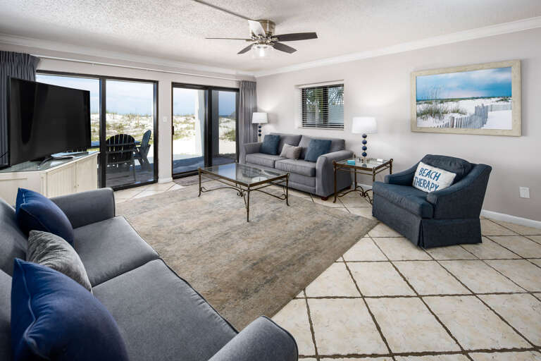 Living room with floor-to-ceiling sliders leading to the back porch
