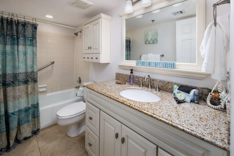 The guest bathroom has a shower/tub combo