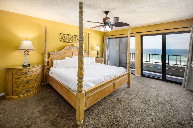 Master bedroom with king size bed and balcony access