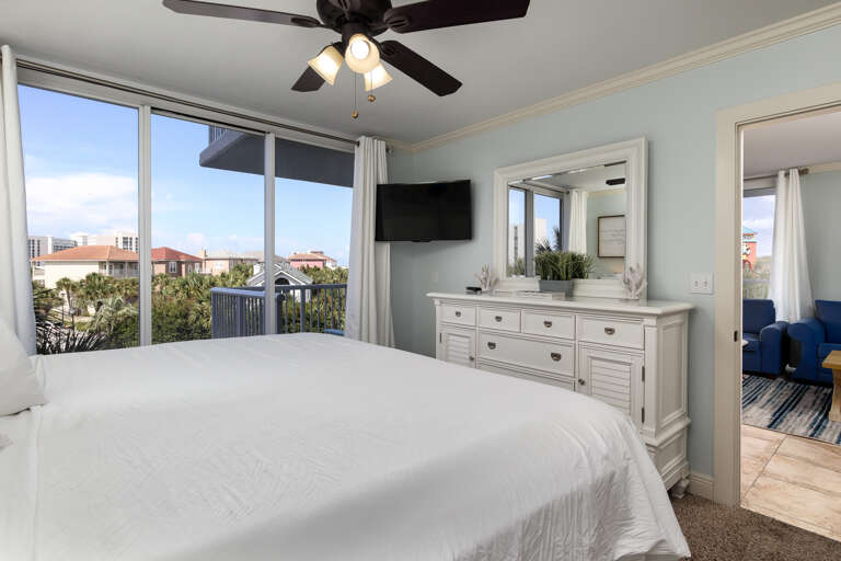 Master bedroom with TV and balcony access