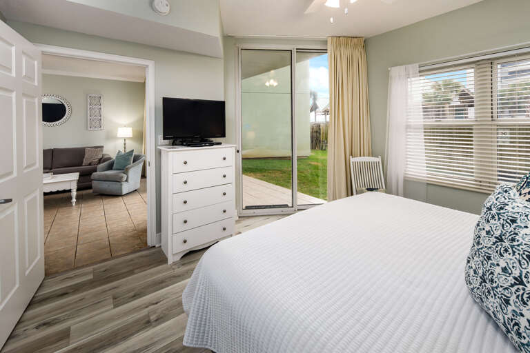 Master bedroom with TV and slider to outdoor patio