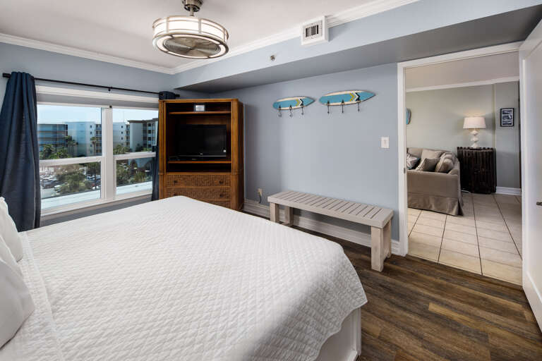 Master bedroom with king size bed and TV